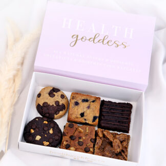 A box of cookies and brownies with the words " health goddess ".