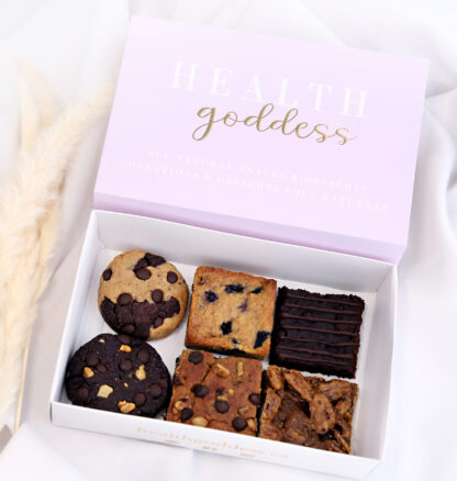 A box of cookies and brownies with the words " health goddess ".
